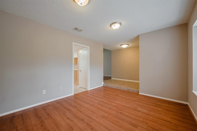 3031 The Highlands Dr, Sugar Land, TX 77478 - unfurnished room with wood finished floors and a textured ceiling
