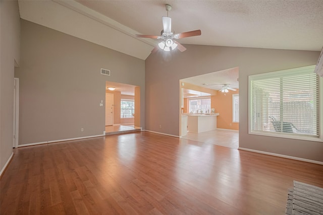 3031 The Highlands Dr, Sugar Land, TX 77478 - unfurnished living room featuring high vaulted ceiling, a ceiling fan, and wood finished floors