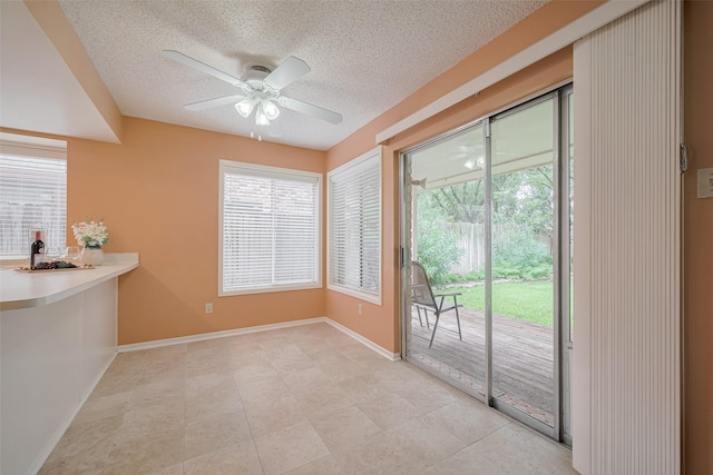 3031 The Highlands Dr, Sugar Land, TX 77478 - unfurnished dining area featuring a textured ceiling, a ceiling fan, and light tile patterned flooring