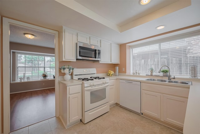3031 The Highlands Dr, Sugar Land, TX 77478 - kitchen featuring white appliances, light countertops, white cabinets, and recessed lighting