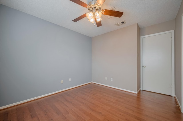 3031 The Highlands Dr, Sugar Land, TX 77478 - empty room featuring wood finished floors, ceiling fan, and a textured ceiling