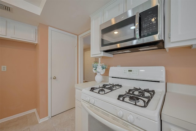 3031 The Highlands Dr, Sugar Land, TX 77478 - kitchen with gas range gas stove, stainless steel microwave, white cabinets, and light tile patterned floors