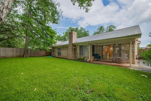 3031 The Highlands Dr, Sugar Land, TX 77478 - rear view of house featuring a fenced backyard, a wooden deck, a chimney, brick siding, and a shingled roof