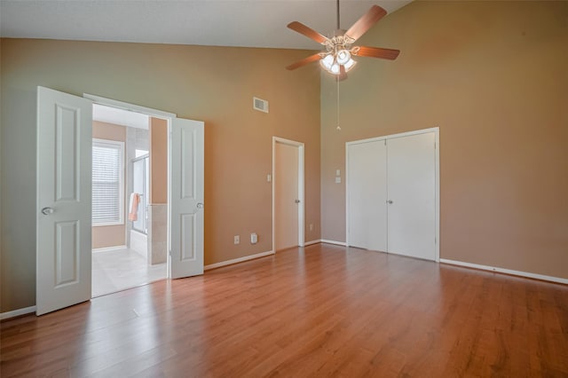 3031 The Highlands Dr, Sugar Land, TX 77478 - unfurnished bedroom with high vaulted ceiling, wood finished floors, and a ceiling fan