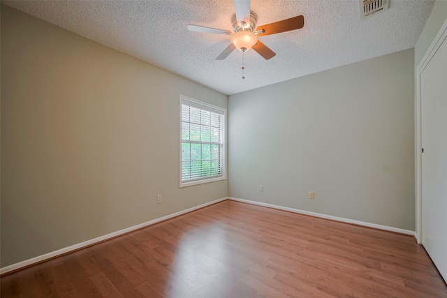 3031 The Highlands Dr, Sugar Land, TX 77478 - spare room with wood finished floors, a ceiling fan, and a textured ceiling