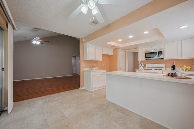 3031 The Highlands Dr, Sugar Land, TX 77478 - kitchen featuring stainless steel microwave, ceiling fan, white gas stove, white cabinets, and light countertops