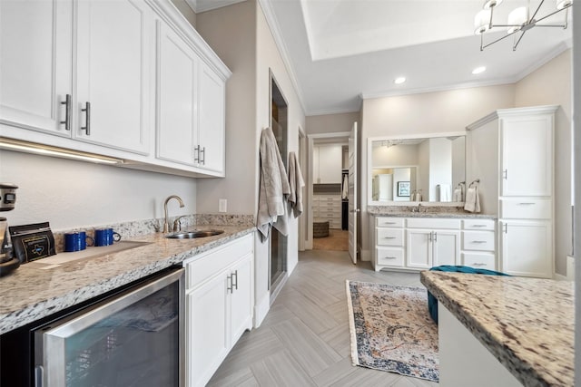 1746 Du Barry Ln, Houston, TX 77018 - kitchen featuring beverage cooler, crown molding, white cabinets, light stone countertops, and recessed lighting