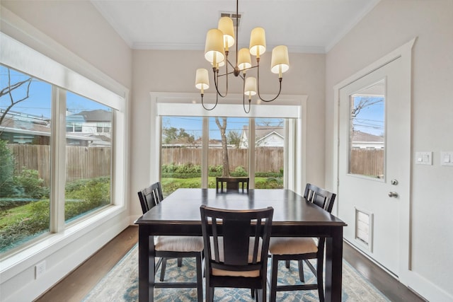1746 Du Barry Ln, Houston, TX 77018 - dining area with ornamental molding, wood finished floors, and a chandelier