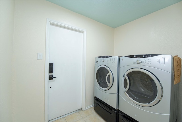 25418 Sugar Valley Ln, Spring, TX 77373 - laundry room featuring washing machine and dryer and light tile patterned flooring