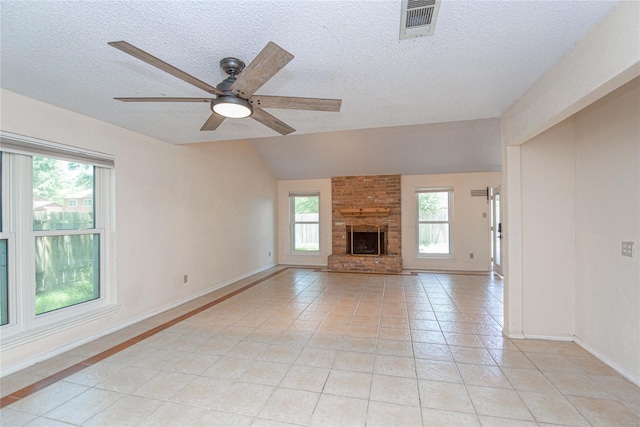25418 Sugar Valley Ln, Spring, TX 77373 - unfurnished living room featuring ceiling fan, a textured ceiling, light tile patterned floors, vaulted ceiling, and a brick fireplace
