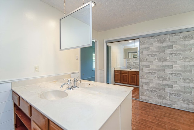 25418 Sugar Valley Ln, Spring, TX 77373 - bathroom with vanity, wood finished floors, and a textured ceiling