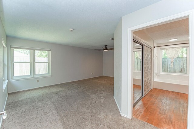 25418 Sugar Valley Ln, Spring, TX 77373 - empty room with a ceiling fan, plenty of natural light, light carpet, and a textured ceiling