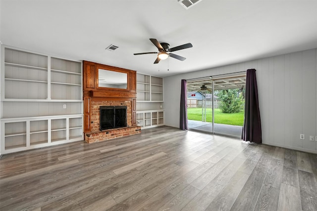 8503 Leader St, Houston, TX 77036 - unfurnished living room featuring a ceiling fan, a brick fireplace, wood finished floors, and built in features