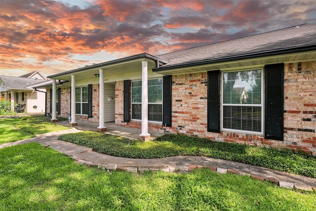 8503 Leader St, Houston, TX 77036 - view of front of house featuring brick siding, a front yard, a shingled roof, and covered porch