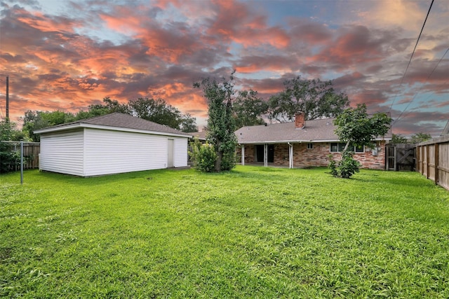 8503 Leader St, Houston, TX 77036 - yard at dusk with a fenced backyard and an outdoor structure