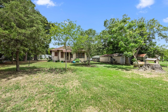 600 Brazos St, Glidden, TX 78943 - view of green lawn featuring a sunroom