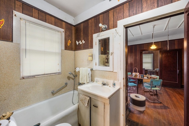 600 Brazos St, Glidden, TX 78943 - bathroom with a tub, wood finished floors, wood walls, and vanity