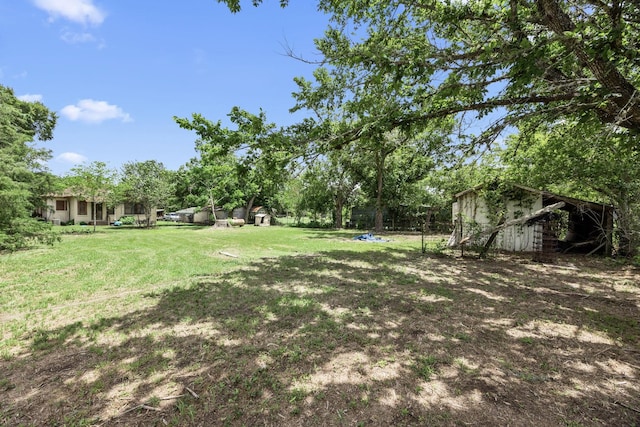 600 Brazos St, Glidden, TX 78943 - view of green lawn featuring a storage shed