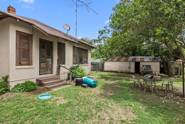 600 Brazos St, Glidden, TX 78943 - view of yard with entry steps and an outbuilding
