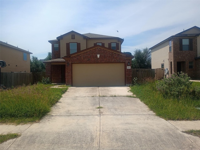 509 Estes Park, Taylor, TX 76574 - traditional-style house featuring a garage, concrete driveway, and brick siding