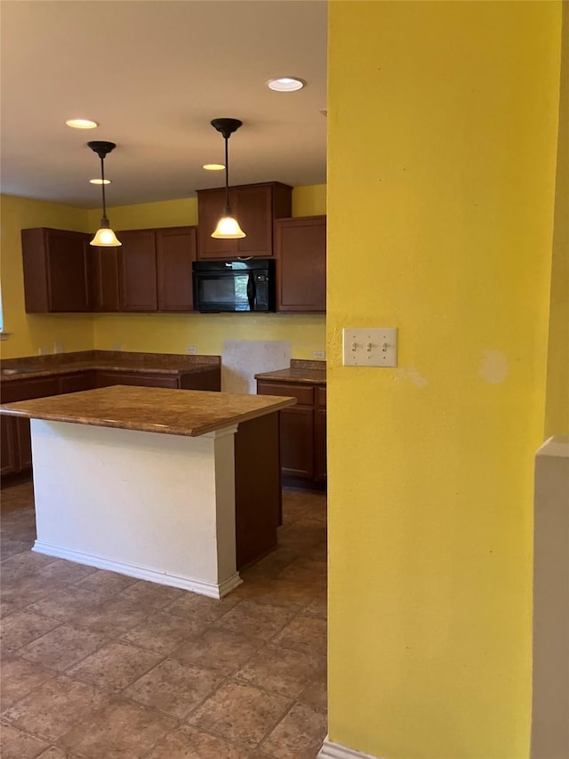 509 Estes Park, Taylor, TX 76574 - kitchen with black microwave, pendant lighting, a center island, and recessed lighting
