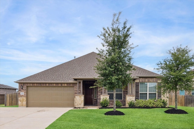 1502 Trails Of Katy Ln, Katy, TX 77494 - view of front of house with driveway, a shingled roof, an attached garage, and stone siding