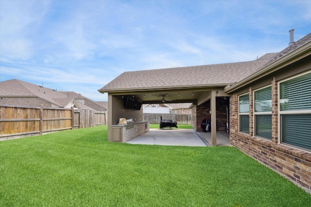 1502 Trails Of Katy Ln, Katy, TX 77494 - fenced backyard featuring exterior kitchen, a patio area, and ceiling fan