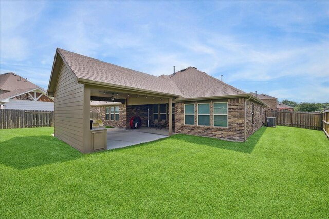 1502 Trails Of Katy Ln, Katy, TX 77494 - rear view of property featuring a patio, brick siding, a fenced backyard, and a shingled roof