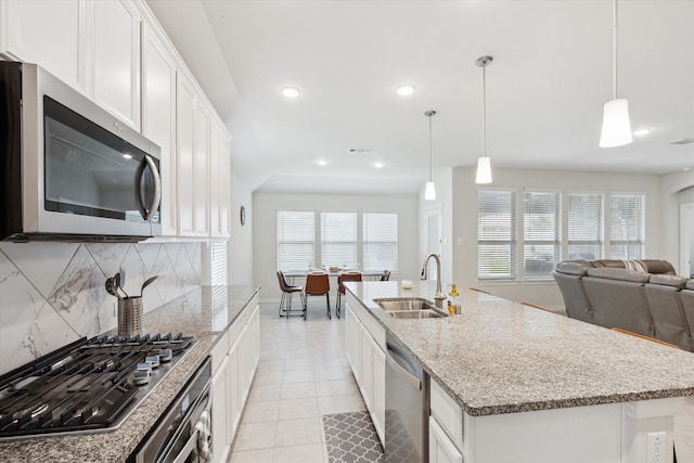 1502 Trails Of Katy Ln, Katy, TX 77494 - kitchen featuring stainless steel appliances, tasteful backsplash, open floor plan, light tile patterned flooring, and plenty of natural light