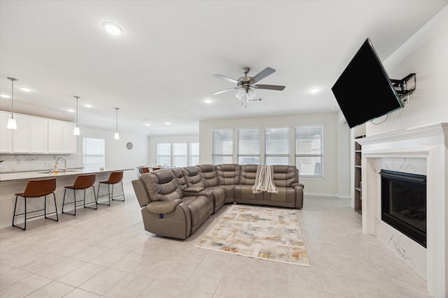 1502 Trails Of Katy Ln, Katy, TX 77494 - living area with light tile patterned floors, ceiling fan, recessed lighting, a high end fireplace, and built in shelves