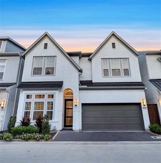 3615 Weston Manor Ln, Houston, TX 77055 - view of front of home with brick siding, an attached garage, and driveway