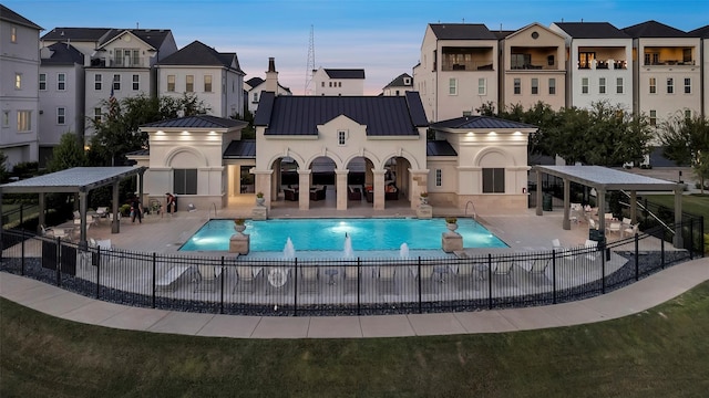 3615 Weston Manor Ln, Houston, TX 77055 - pool at dusk with a community pool and a patio