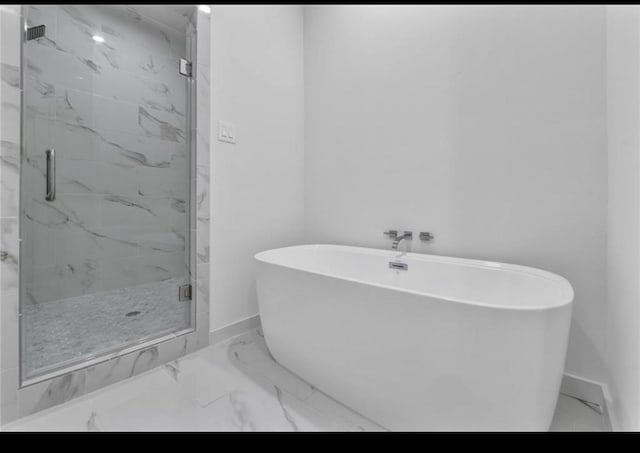 209 Edgewood St Unit C, Houston, TX 77011 - full bath featuring marble look tile flooring, a marble finish shower, and a freestanding bath
