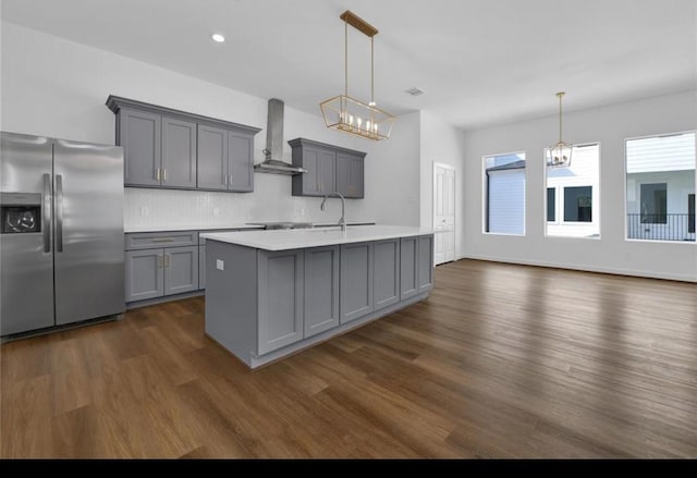 209 Edgewood St Unit C, Houston, TX 77011 - kitchen featuring stainless steel fridge, wall chimney range hood, gray cabinetry, dark wood-style flooring, and light countertops