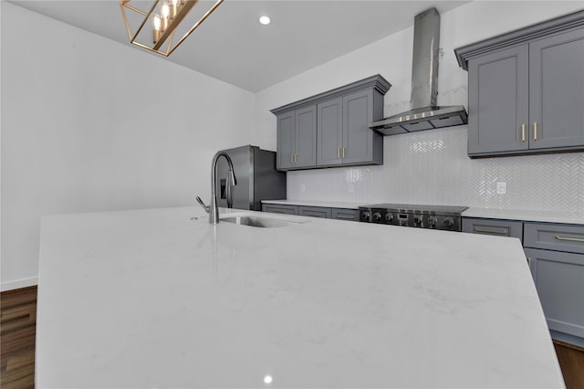 209 Edgewood St Unit C, Houston, TX 77011 - kitchen featuring wall chimney exhaust hood, stainless steel refrigerator with ice dispenser, tasteful backsplash, dark wood finished floors, and gray cabinetry