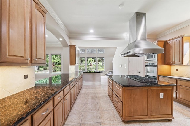 5215 Eagle Pointe Ct, Sugar Land, TX 77479 - kitchen with island range hood, stainless steel appliances, crown molding, tasteful backsplash, and dark stone countertops
