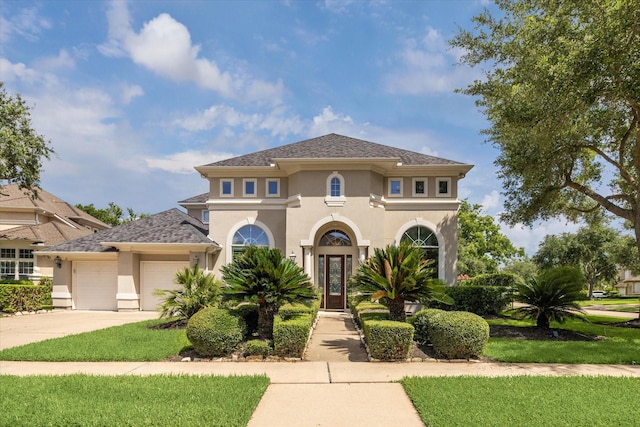 5215 Eagle Pointe Ct, Sugar Land, TX 77479 - mediterranean / spanish-style house featuring stucco siding, a garage, concrete driveway, and a front lawn