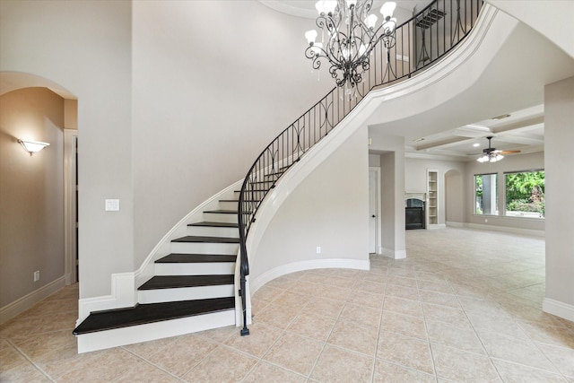 5215 Eagle Pointe Ct, Sugar Land, TX 77479 - staircase with arched walkways, tile patterned flooring, ceiling fan, a high ceiling, and a glass covered fireplace