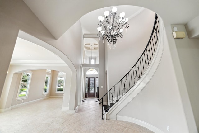 5215 Eagle Pointe Ct, Sugar Land, TX 77479 - entrance foyer featuring a chandelier, tile patterned floors, stairway, arched walkways, and a towering ceiling