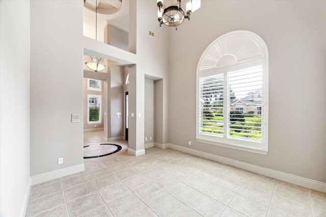 5215 Eagle Pointe Ct, Sugar Land, TX 77479 - spare room featuring light tile patterned flooring, a chandelier, and a towering ceiling