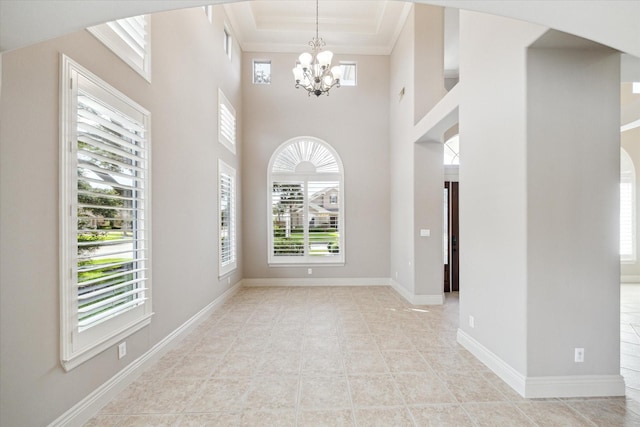 5215 Eagle Pointe Ct, Sugar Land, TX 77479 - entrance foyer with arched walkways, a chandelier, ornamental molding, a high ceiling, and tile patterned floors