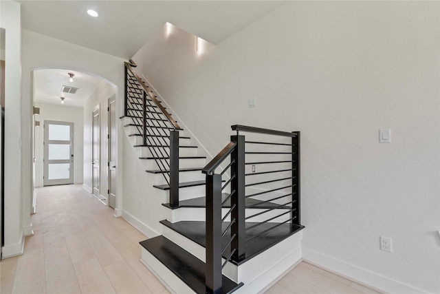 4433 Phlox St, Houston, TX 77051 - stairs featuring arched walkways, recessed lighting, and wood finished floors