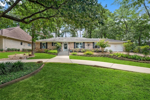 150 Greenbriar Dr, Montgomery, TX 77356 - ranch-style house with concrete driveway, a front yard, brick siding, and a garage