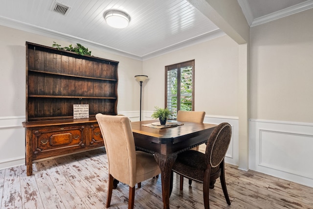 150 Greenbriar Dr, Montgomery, TX 77356 - dining room with light wood finished floors, wainscoting, and crown molding
