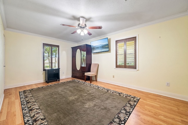 150 Greenbriar Dr, Montgomery, TX 77356 - living area featuring wood finished floors, a ceiling fan, and crown molding
