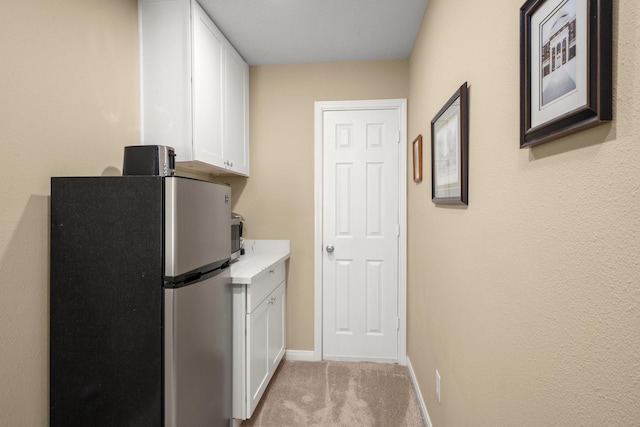 18718 Glenn Haven Estates Dr, Spring, TX 77379 - laundry room with baseboards and light carpet