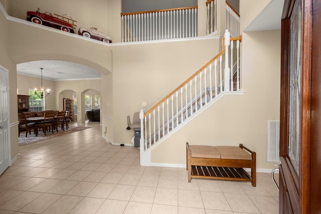 18718 Glenn Haven Estates Dr, Spring, TX 77379 - tiled foyer entrance featuring crown molding, arched walkways, a towering ceiling, and a chandelier