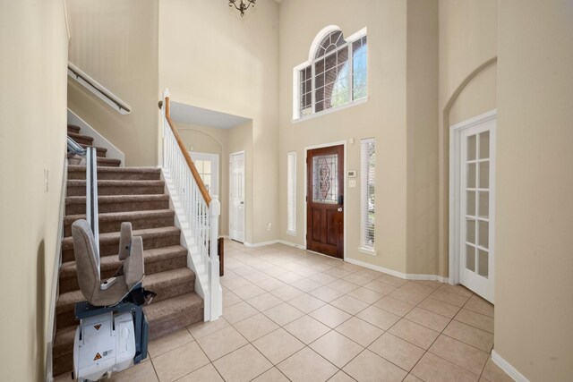 18718 Glenn Haven Estates Dr, Spring, TX 77379 - entrance foyer featuring light tile patterned floors, stairway, and a high ceiling