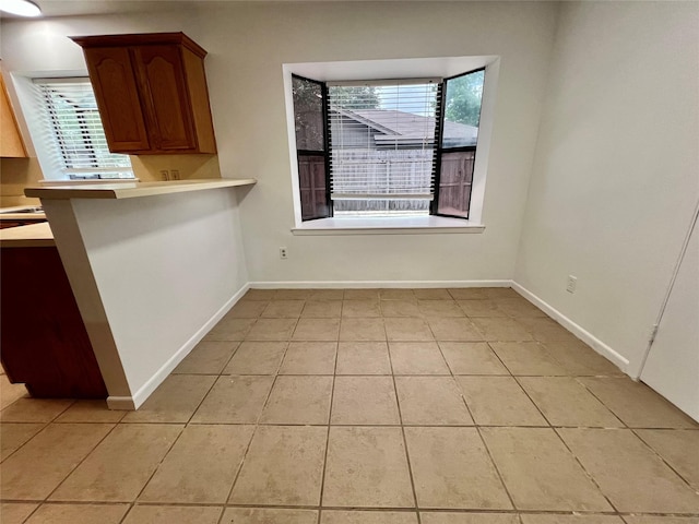 10447 Winding Trail Rd, La Porte, TX 77571 - unfurnished dining area featuring light tile patterned floors and baseboards