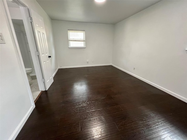 10447 Winding Trail Rd, La Porte, TX 77571 - unfurnished bedroom with dark wood finished floors and connected bathroom